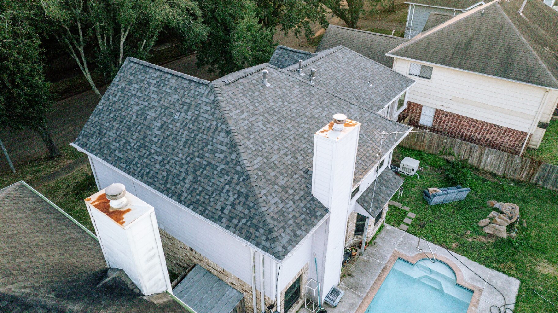 Aerial view of the same Drake Elm home after a full roof replacement with crisp new architectural shingles