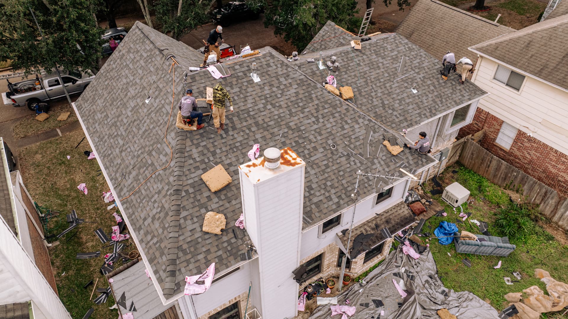 Drone view of new asphalt shingle roof replacement in Houston