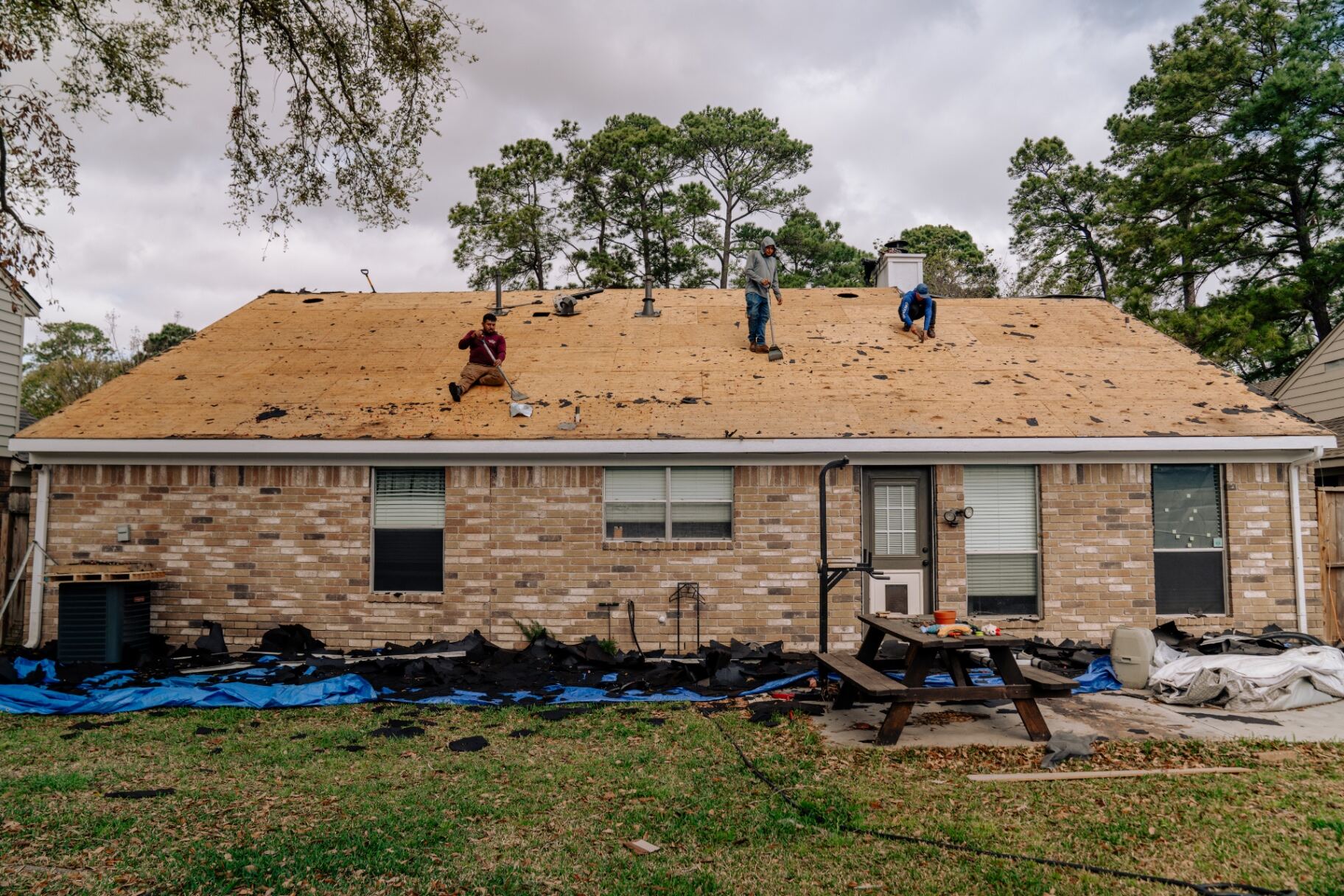 Damaged shingles stripped to the decking during a Houston roof replacement